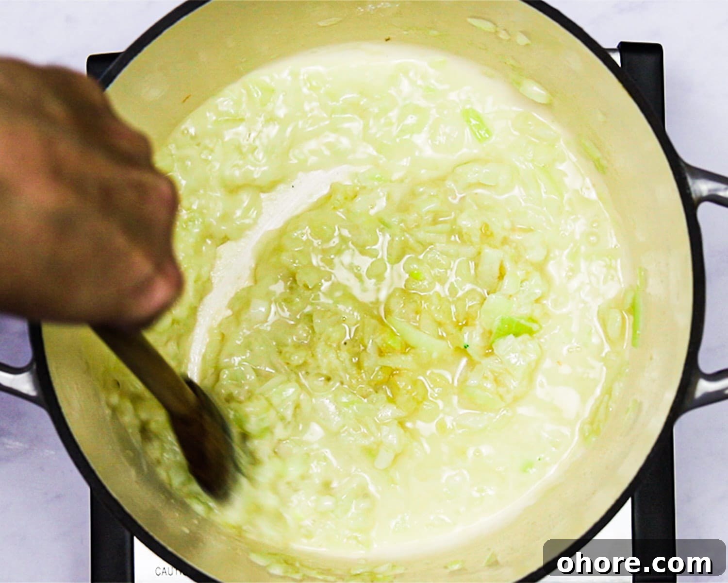 Creamy Broccoli Cheddar Soup Recipe for Cozy Comfort Meal 6 stirring stock into the roux.