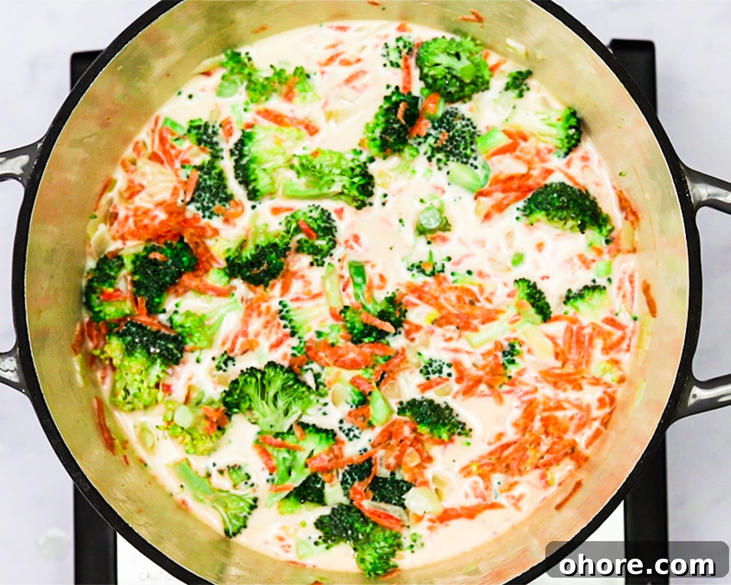 Creamy Broccoli Cheddar Soup Recipe for Cozy Comfort Meal 7 Adding broccoli and carrots to the soup.