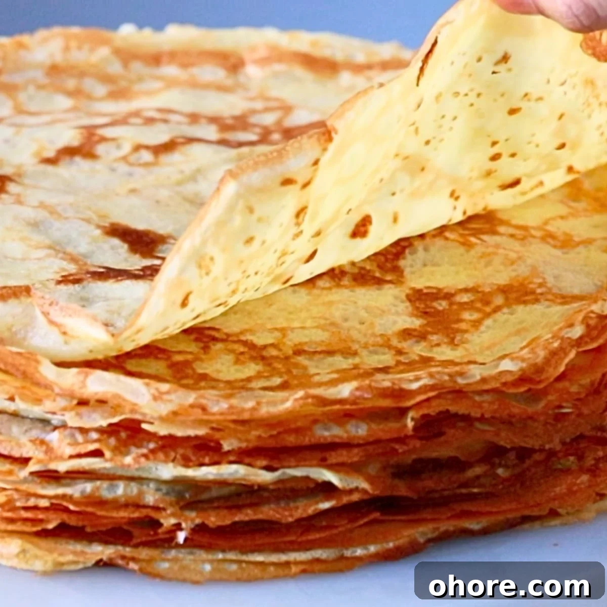 a thin crepe, piled up on a table