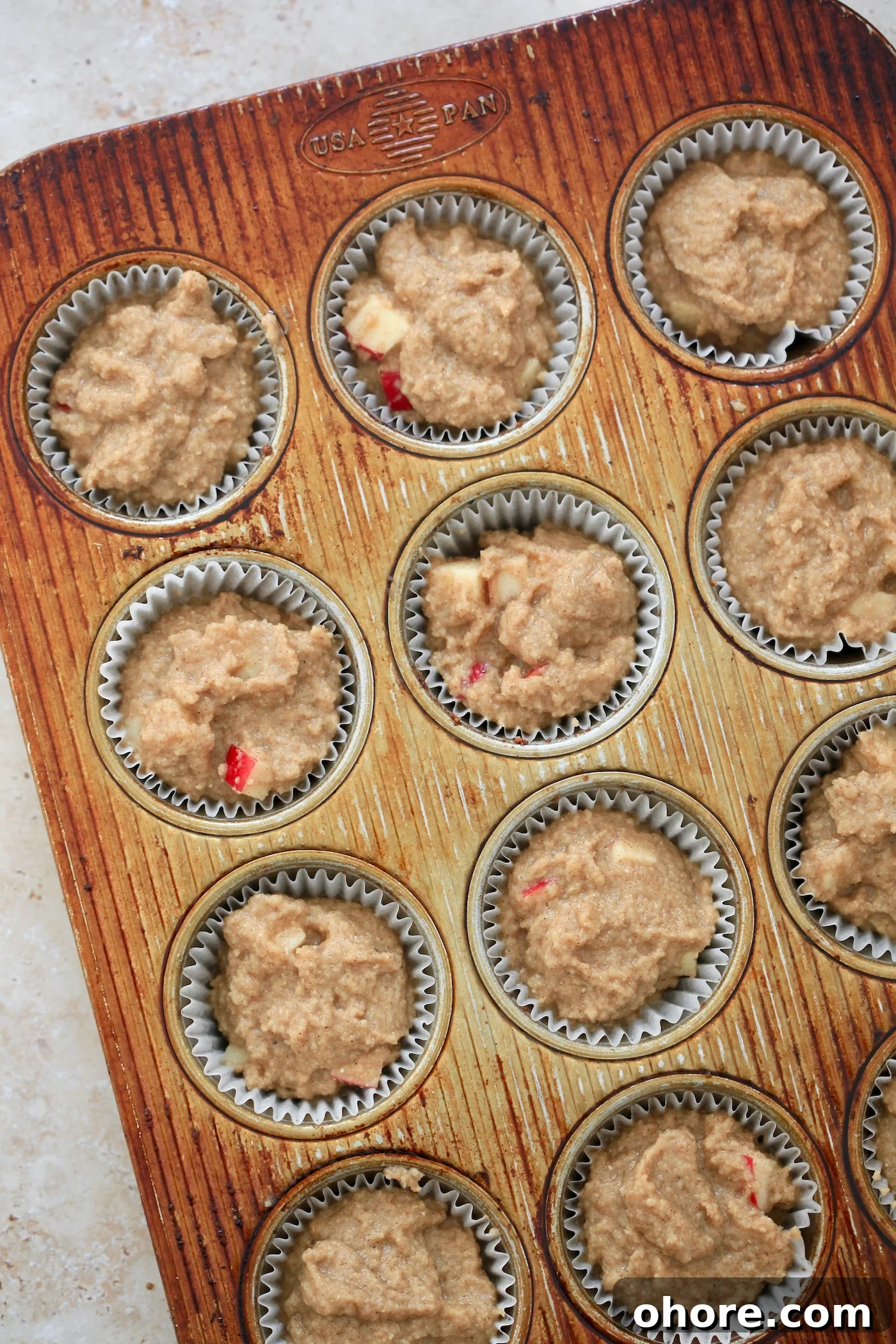 Almond Flour Apple Muffins: Fluffy, Gluten-Free Recipe 6 unbaked batter in muffin tin.