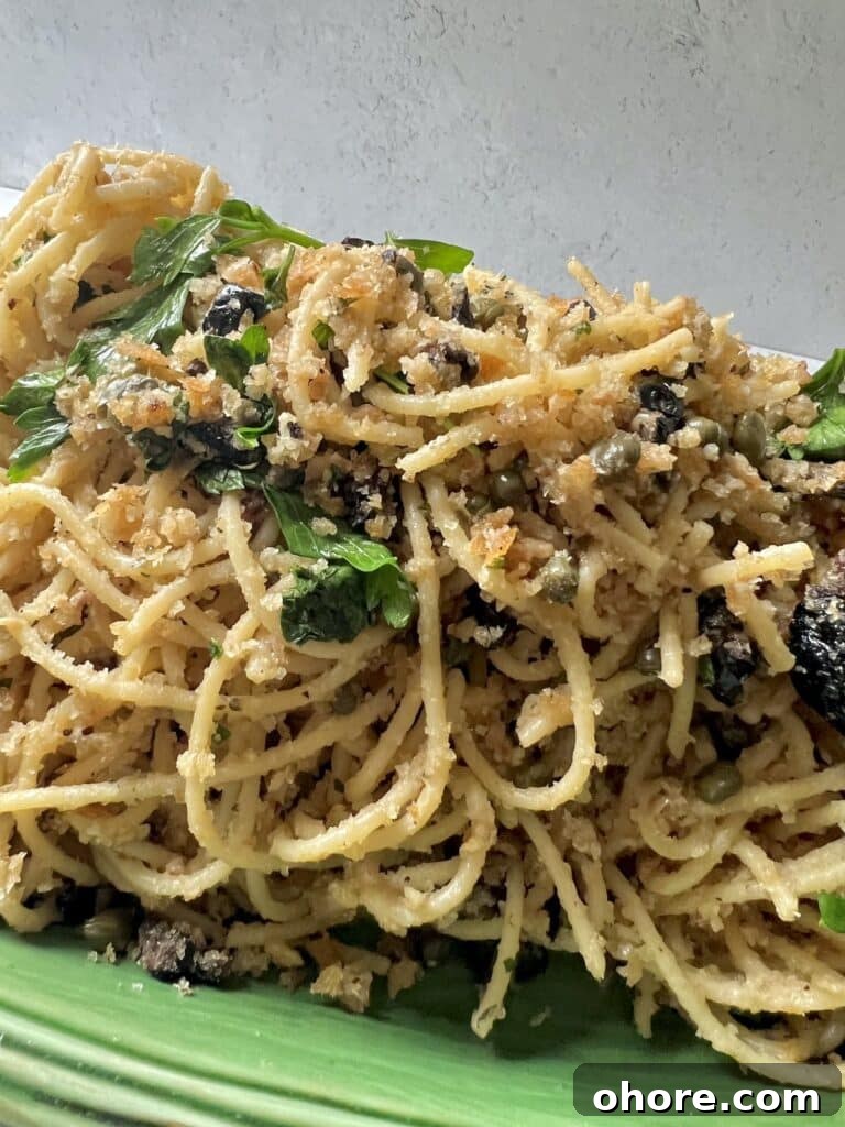St. Joseph’s Spaghetti with Anchovies and Crispy Breadcrumbs 9 Spaghetti with Breadcrumbs and Anchovies on green platter with parsley garnish.