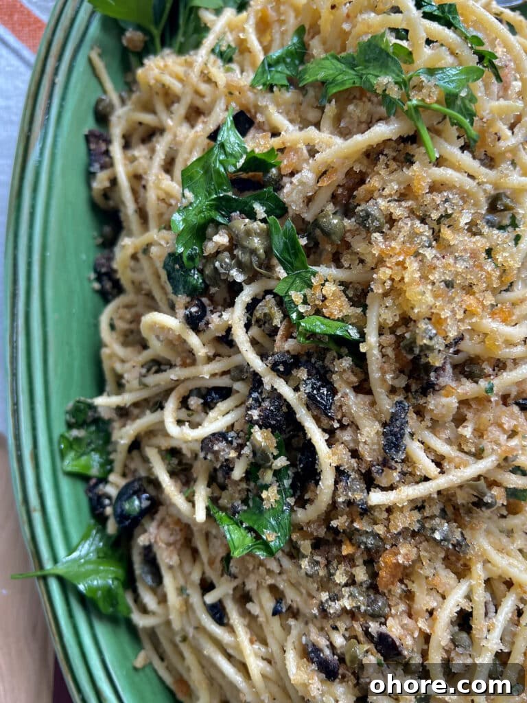 St. Joseph’s Spaghetti with Anchovies and Crispy Breadcrumbs 3 St Joseph's Pasta in green platter with parsley garnish.