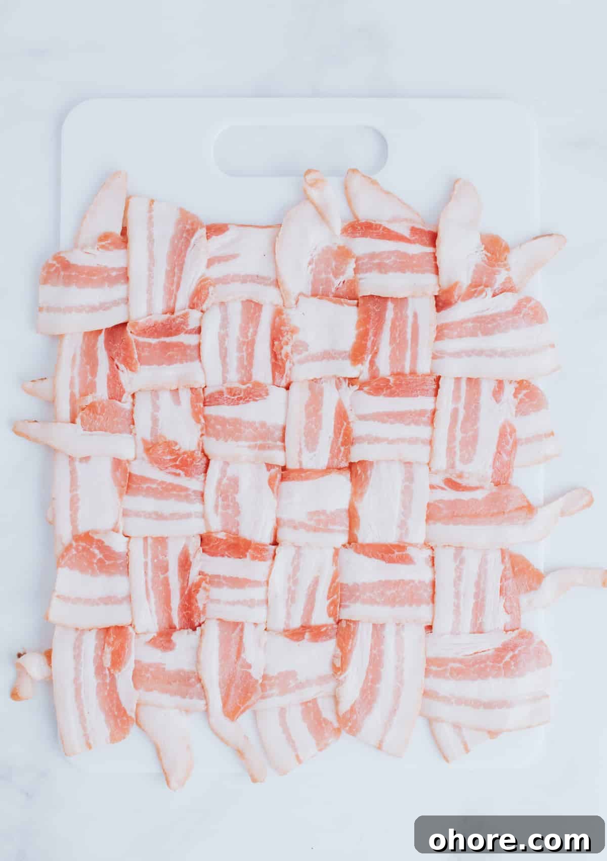 folding strips of bacon on a cutting board