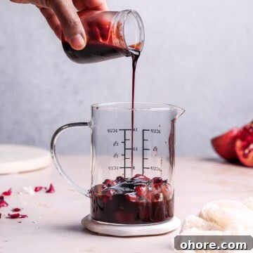 pouring pomegranate sauce in a jar