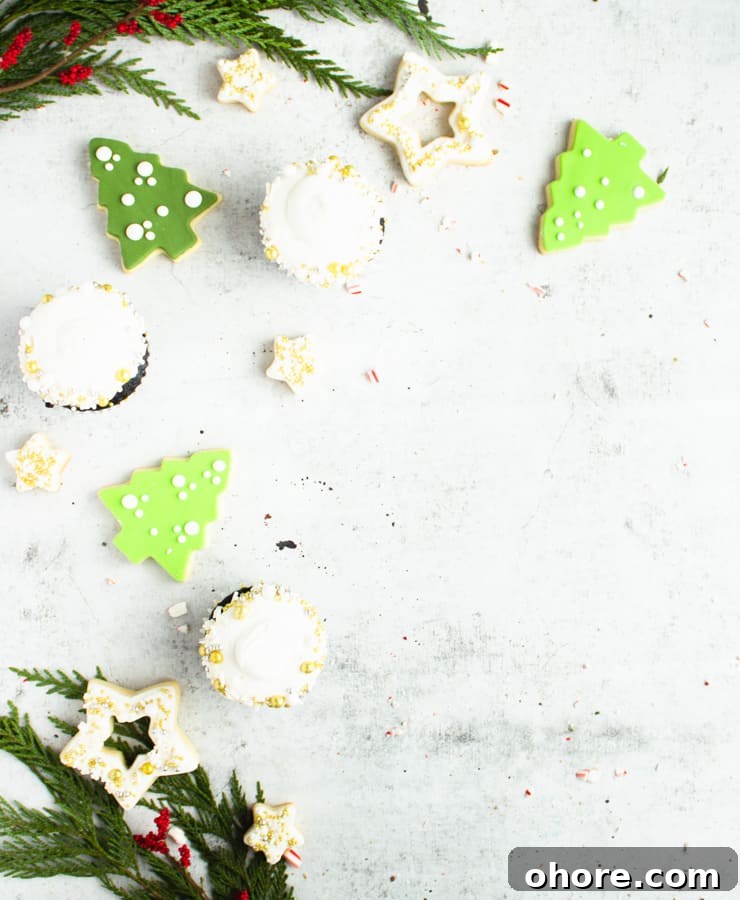 How to Build a Stunning Cookie Board for Parties and Gifts 6 green tree shaped cookies and cupcakes strewn about a concrete surface