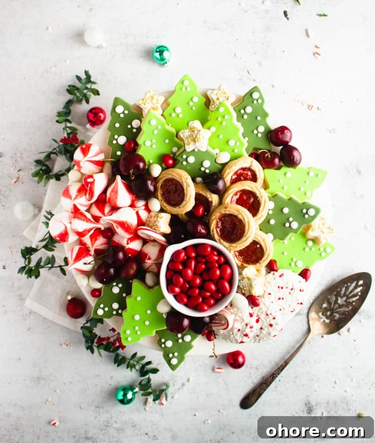 How to Build a Stunning Cookie Board for Parties and Gifts 7 cookie board with green sugar cookie trees, peppermint meringues and thumb print cookies