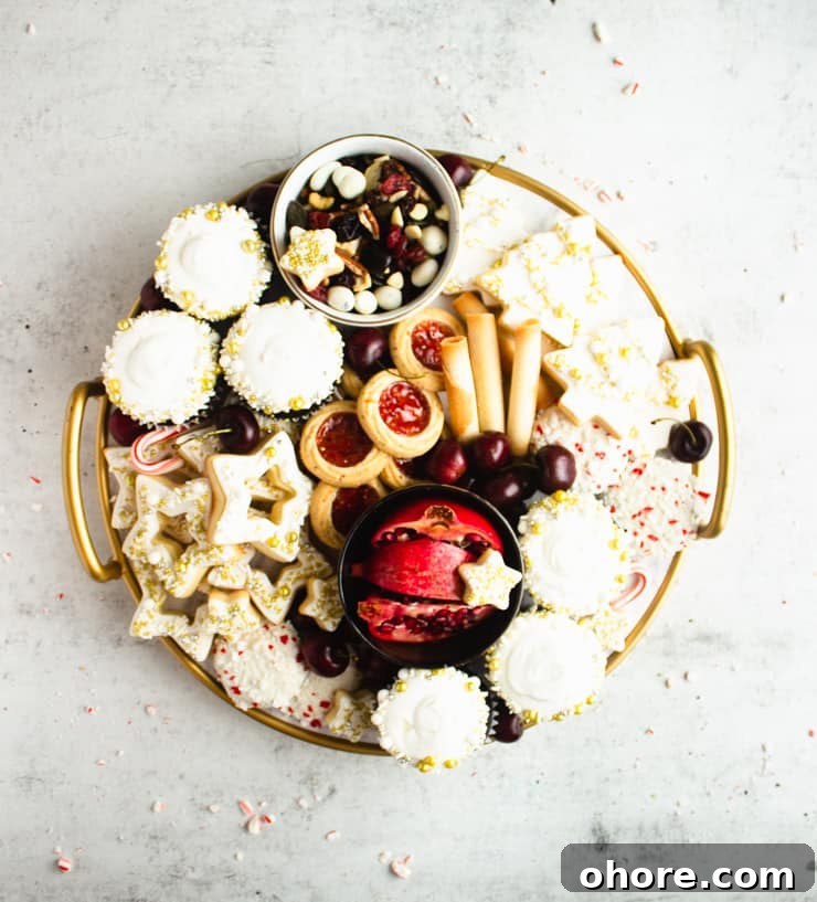 How to Build a Stunning Cookie Board for Parties and Gifts 8 round cookie board with assorted cookies and a bowl of sliced pomegranate