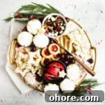 large, round cookie board with fresh fruit, cookies and trail mixe
