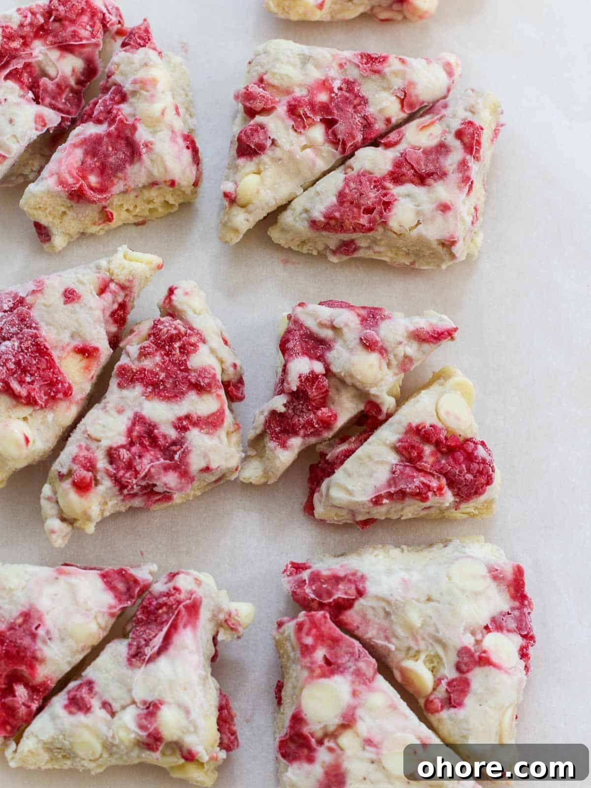 Buttery Raspberry Scones with Lemon Glaze recipe 5 Frozen raspberry scones dough cut and studded with white chocolate chips and sweet red raspberries.