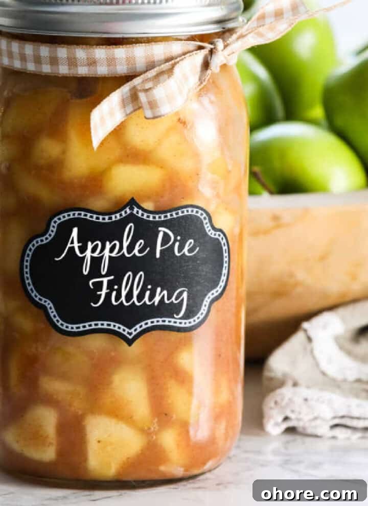 A large jar filled with apple pie filling with a lid and bow.