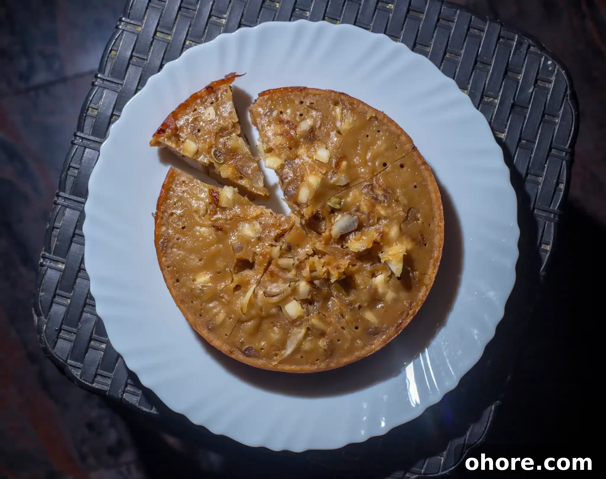 Top view of a plate served with a sliced kalathappam.