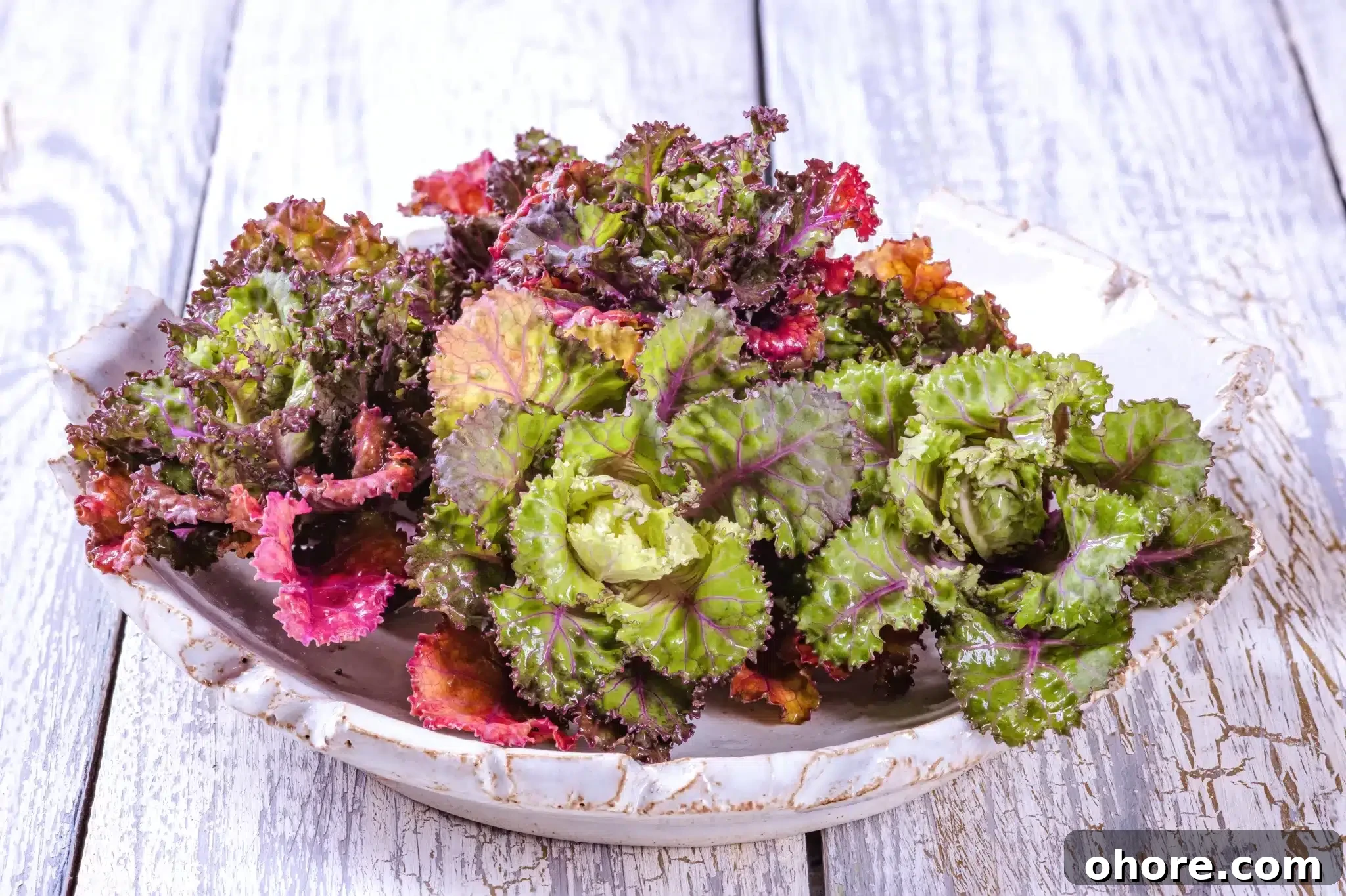 An old wooden table holding a platter full of kalettes.