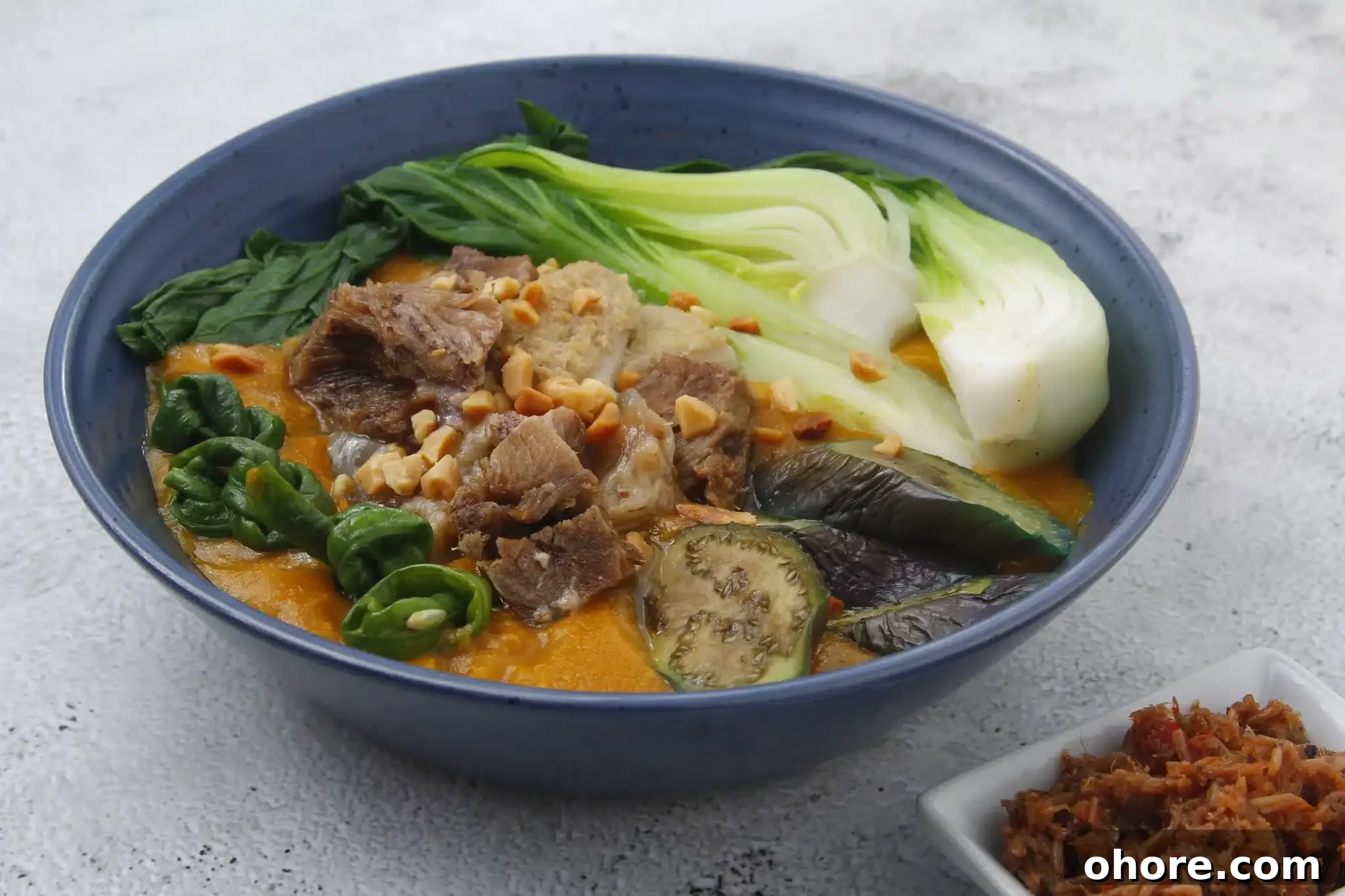 A freshly prepared serving of kare-kare on a platter, ready to be enjoyed.
