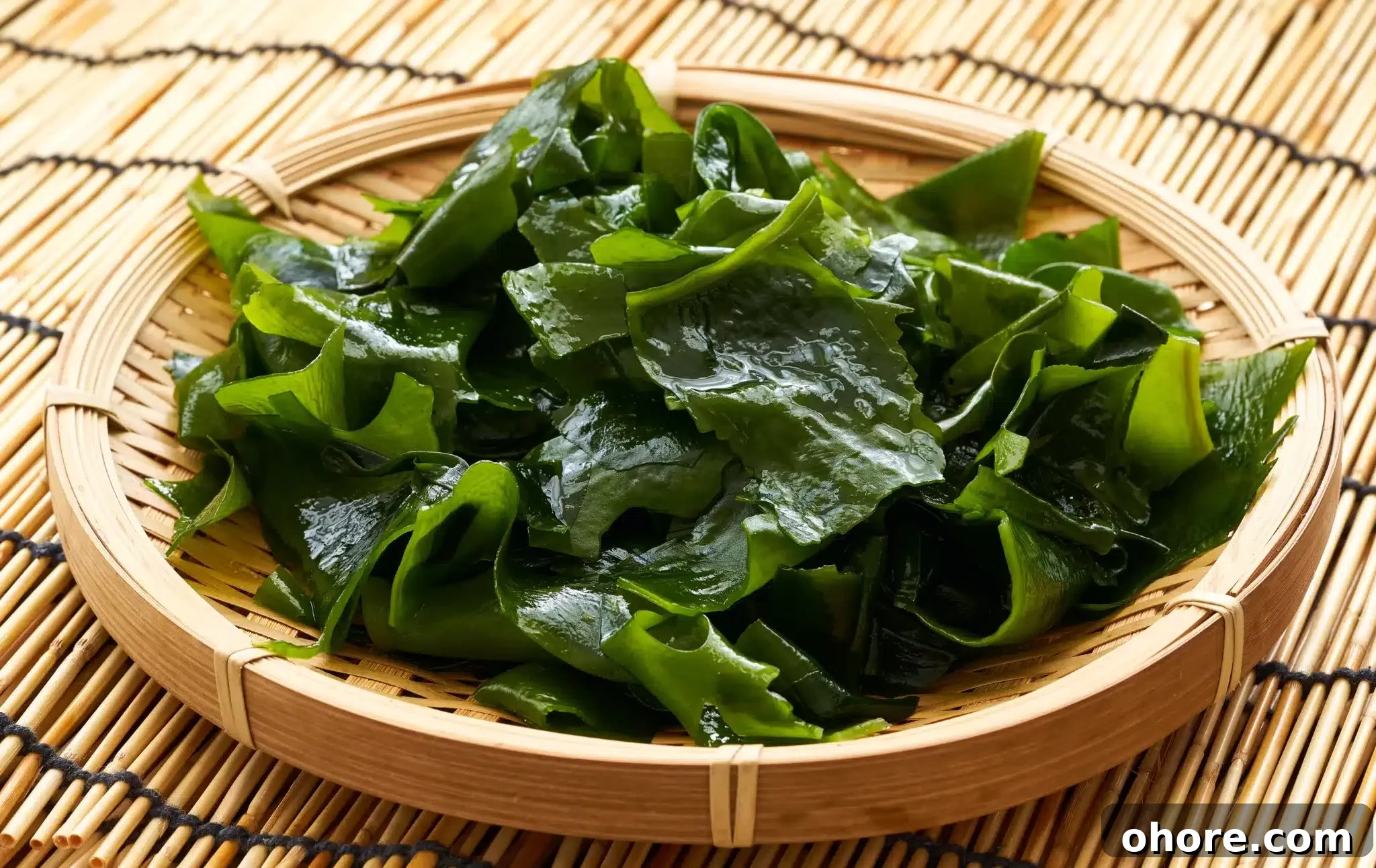 A portion of steamed kelp on a bamboo plate.