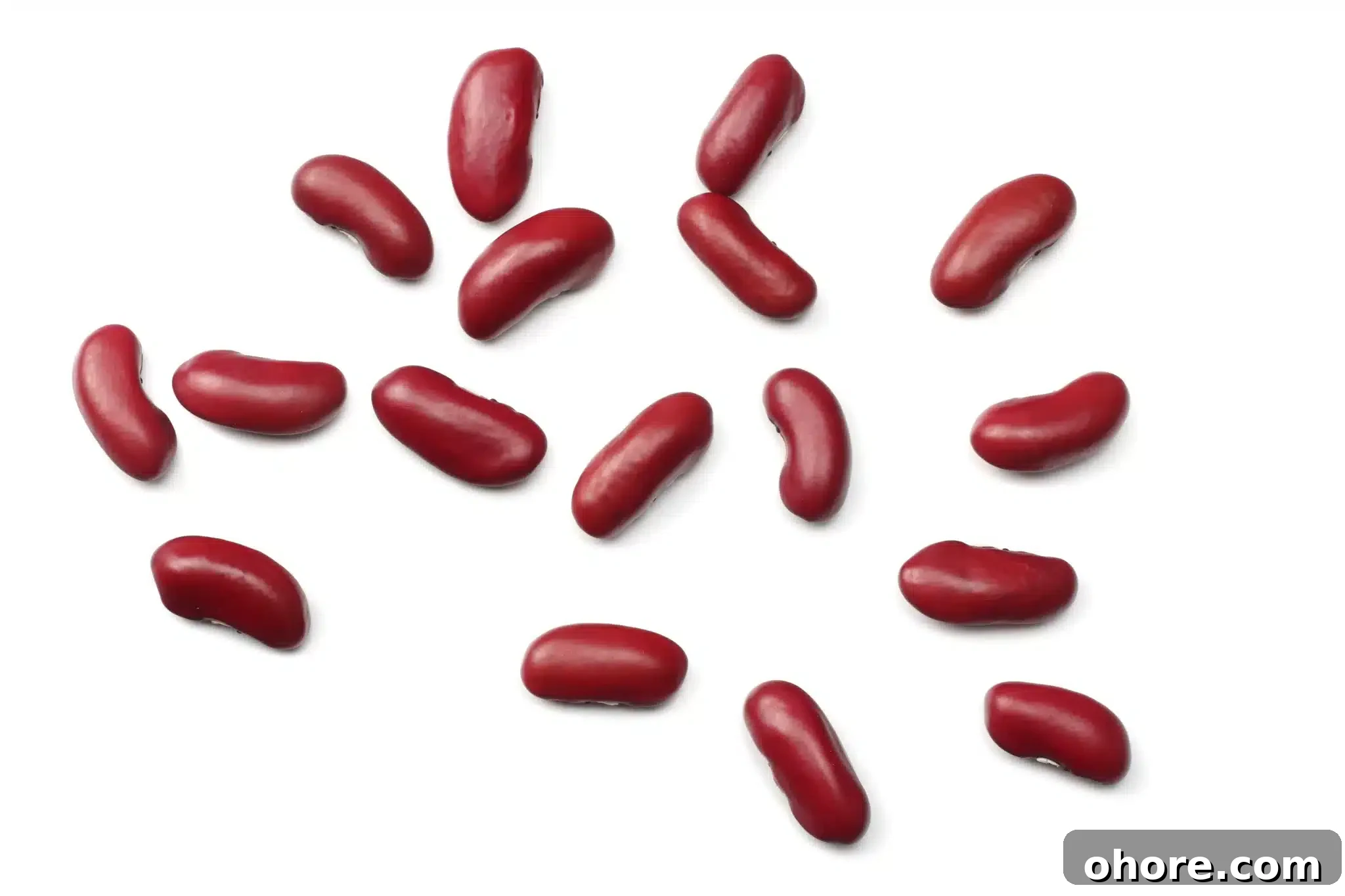 A handful of kidney beans sprinkled on a white surface.