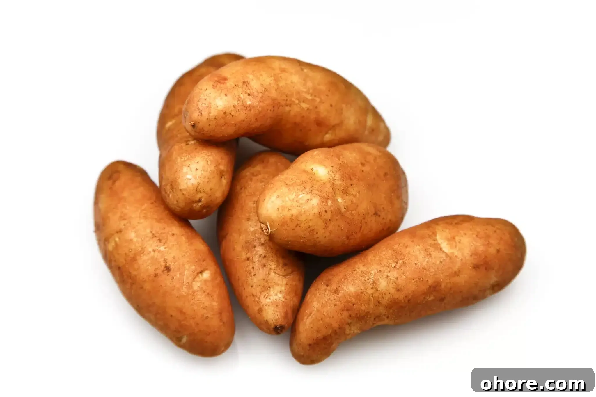 A mound of kipler potatoes depicted against a white backdrop.