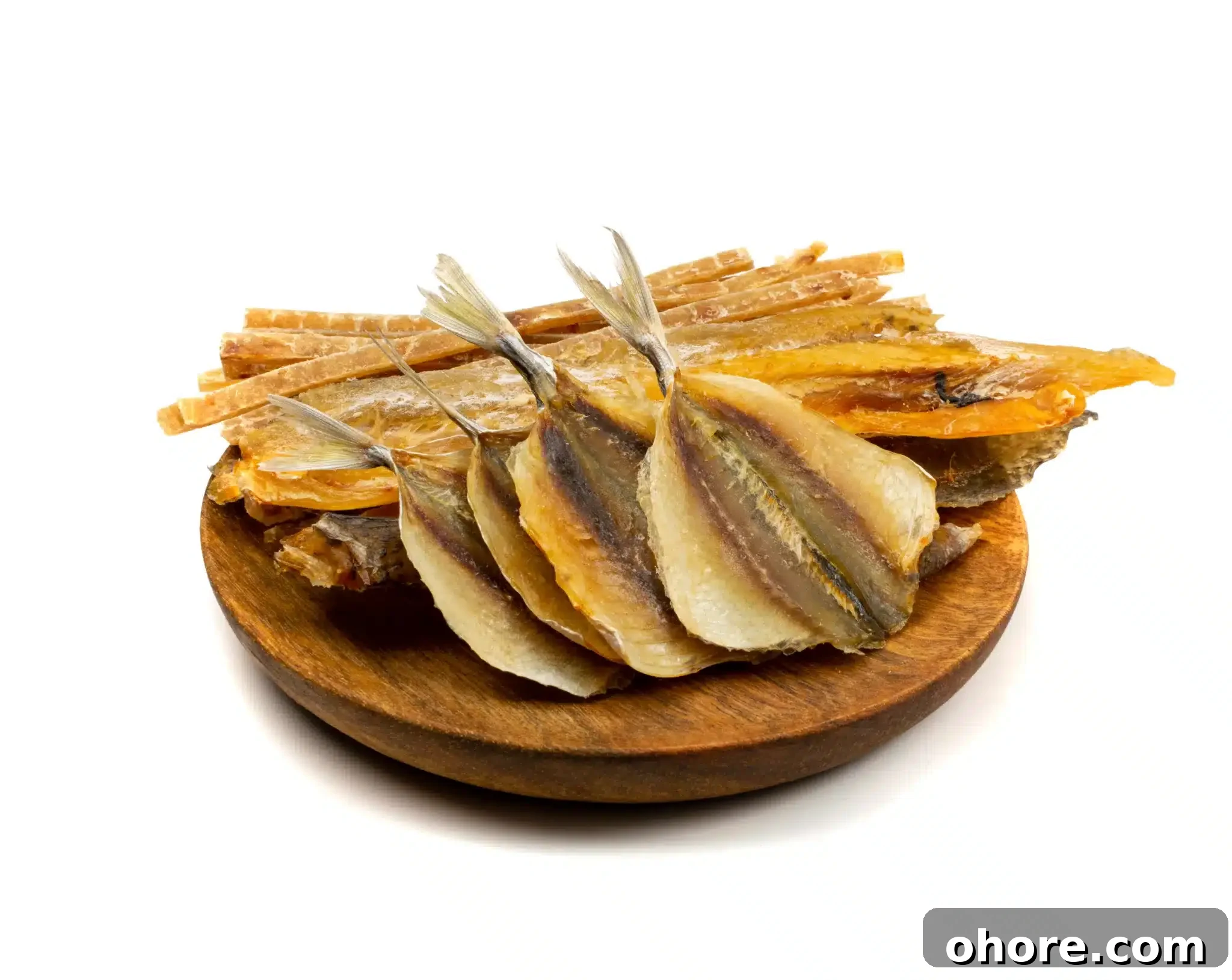 A wooden board showing a pile of kipper snacks.