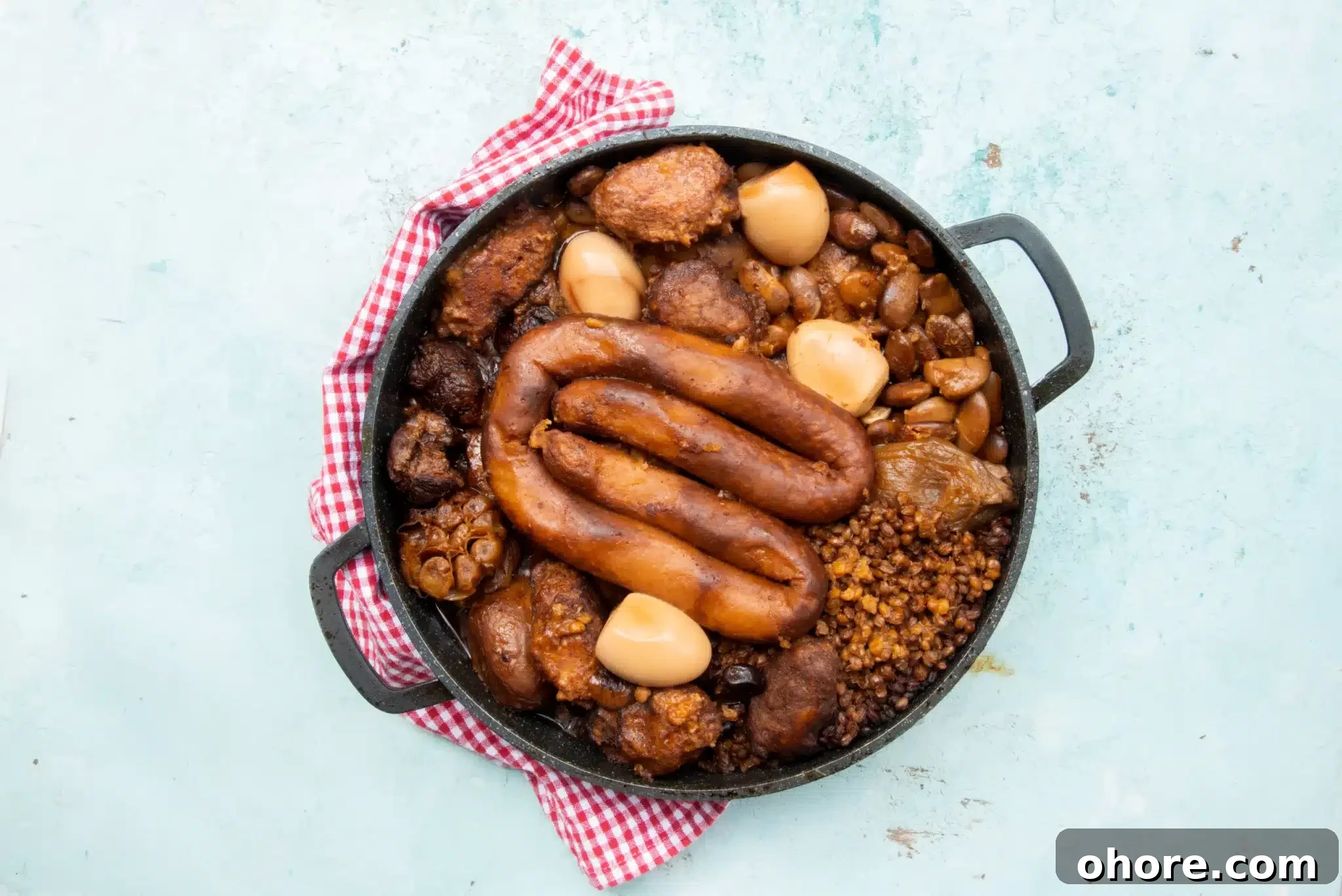 Overhead view of a pan containing kishka.