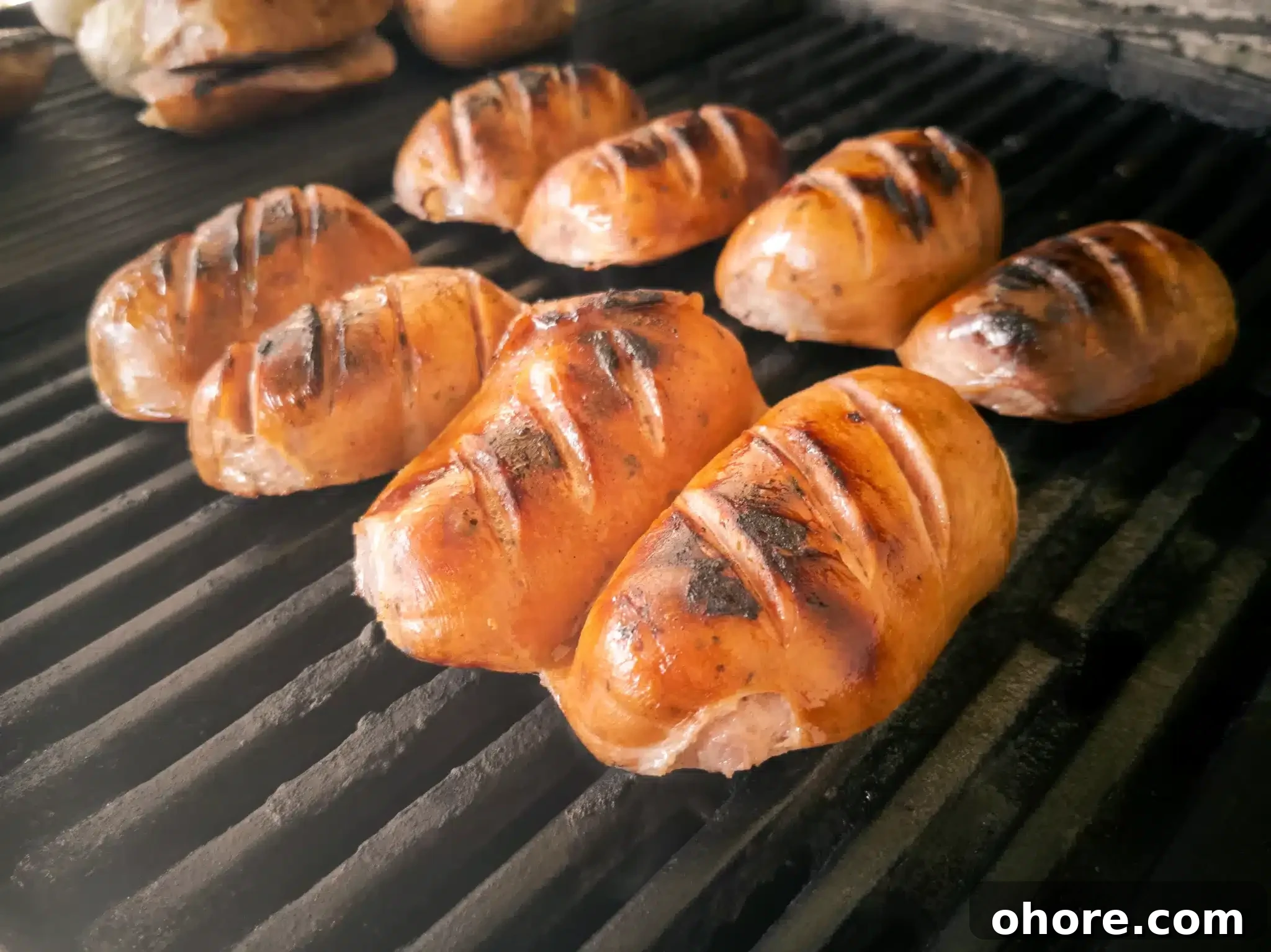 Delicious traditional knackwursts cut in half and roasted on a cast iron rack.