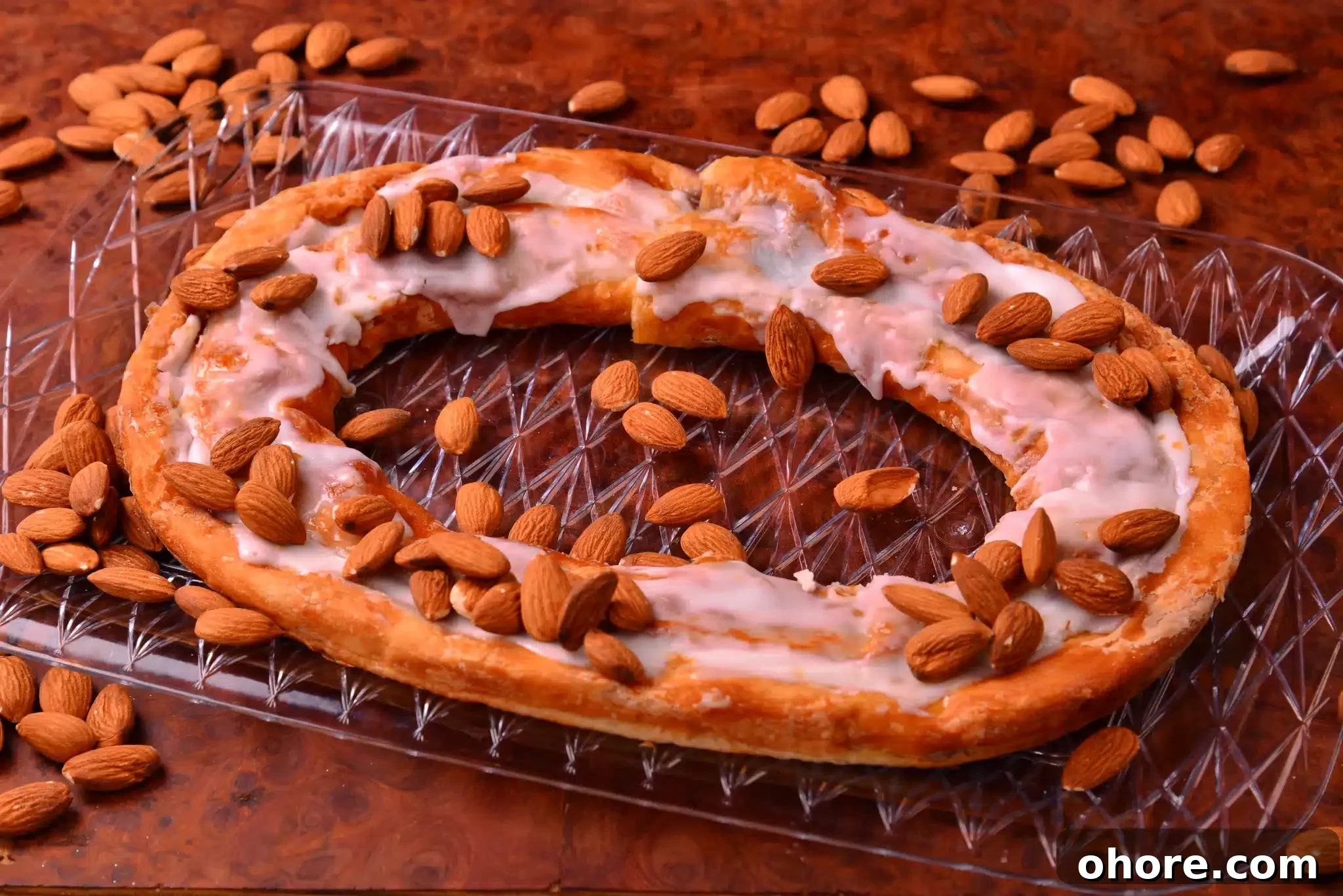 A krindle that has just come out of the oven, adorned with scattered almonds.