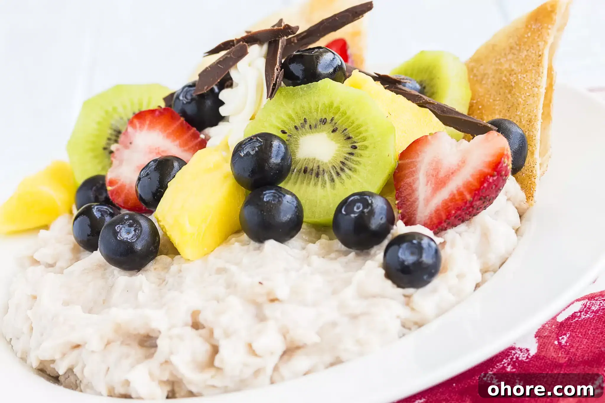 Macro shot of a Kulolo serving garnished with various fruits.