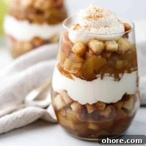 Close up of apple trifle topped with whipped cream.