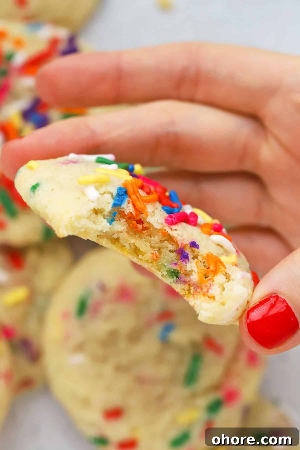 gluten-free sprinkle sugar cookie with a bite taken out of it