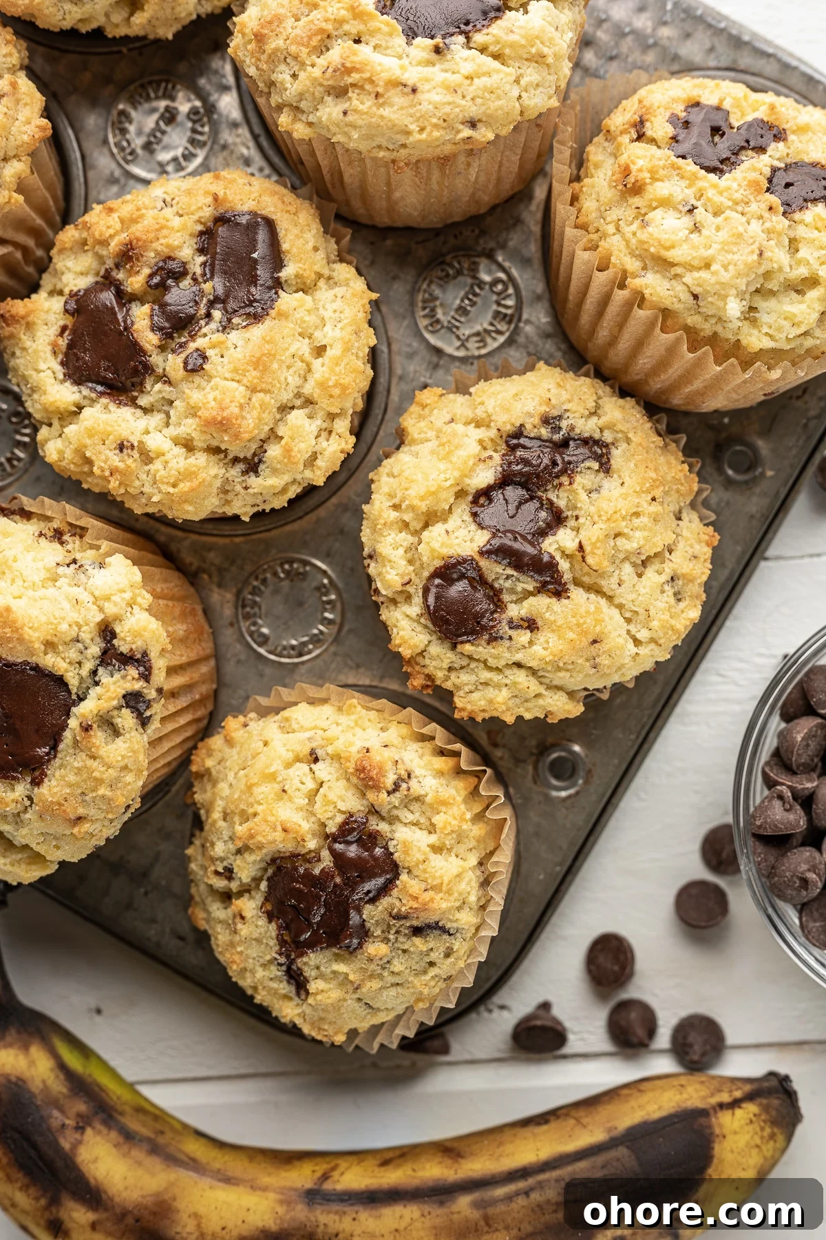 Low-carb banana muffins with chocolate chunks, a keto-friendly and gluten-free breakfast recipe with nostalgic flavors. The image intended to show an example of keto muffin recipes you can make on a carb restricted diet. 