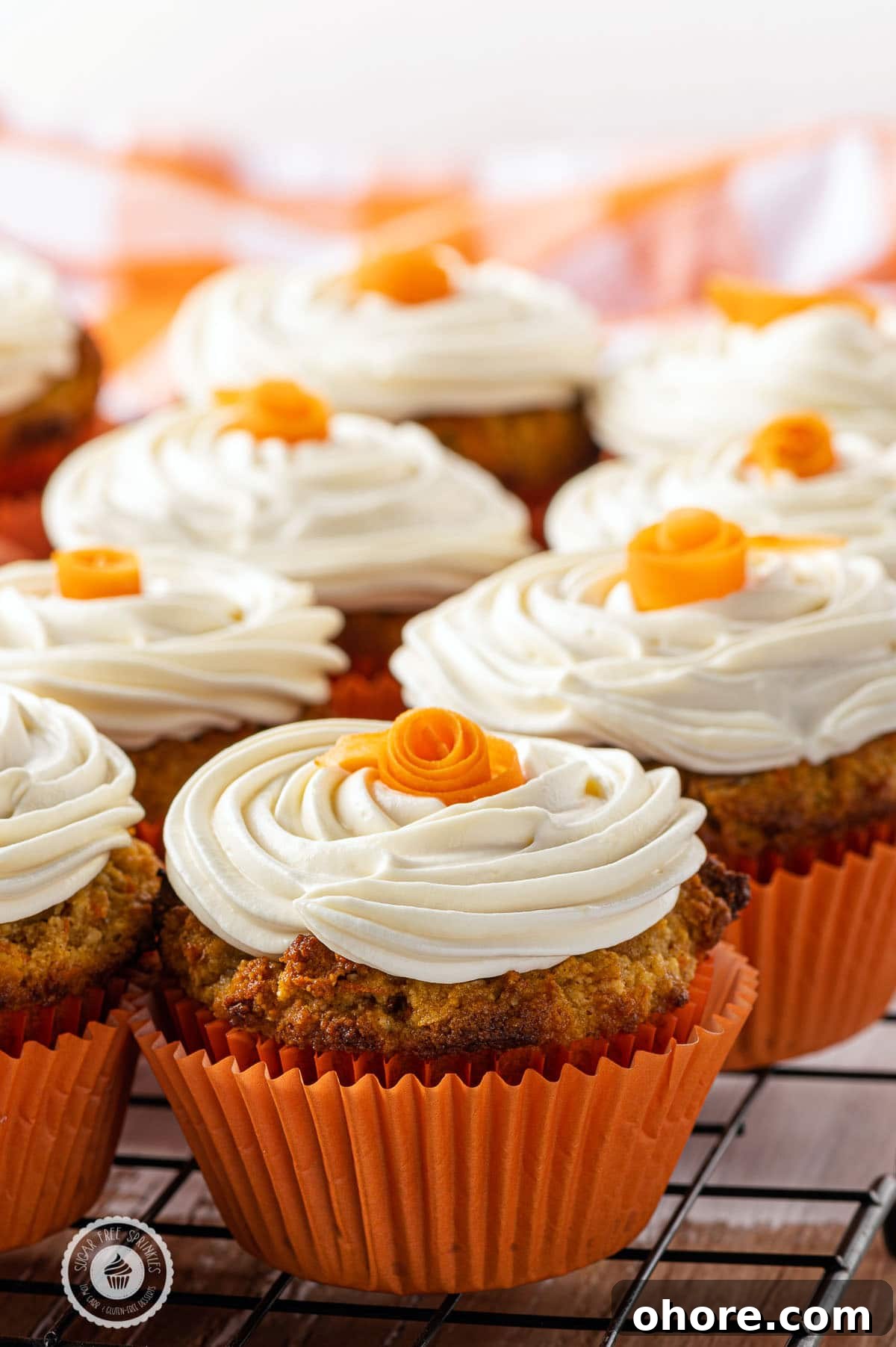 Keto carrot cake muffins with cream cheese frosting, a low-carb, gluten-free breakfast or dessert option for non-egg breakfast lovers. The image intended to show an example of keto muffin recipes you can make on a carb restricted diet. 