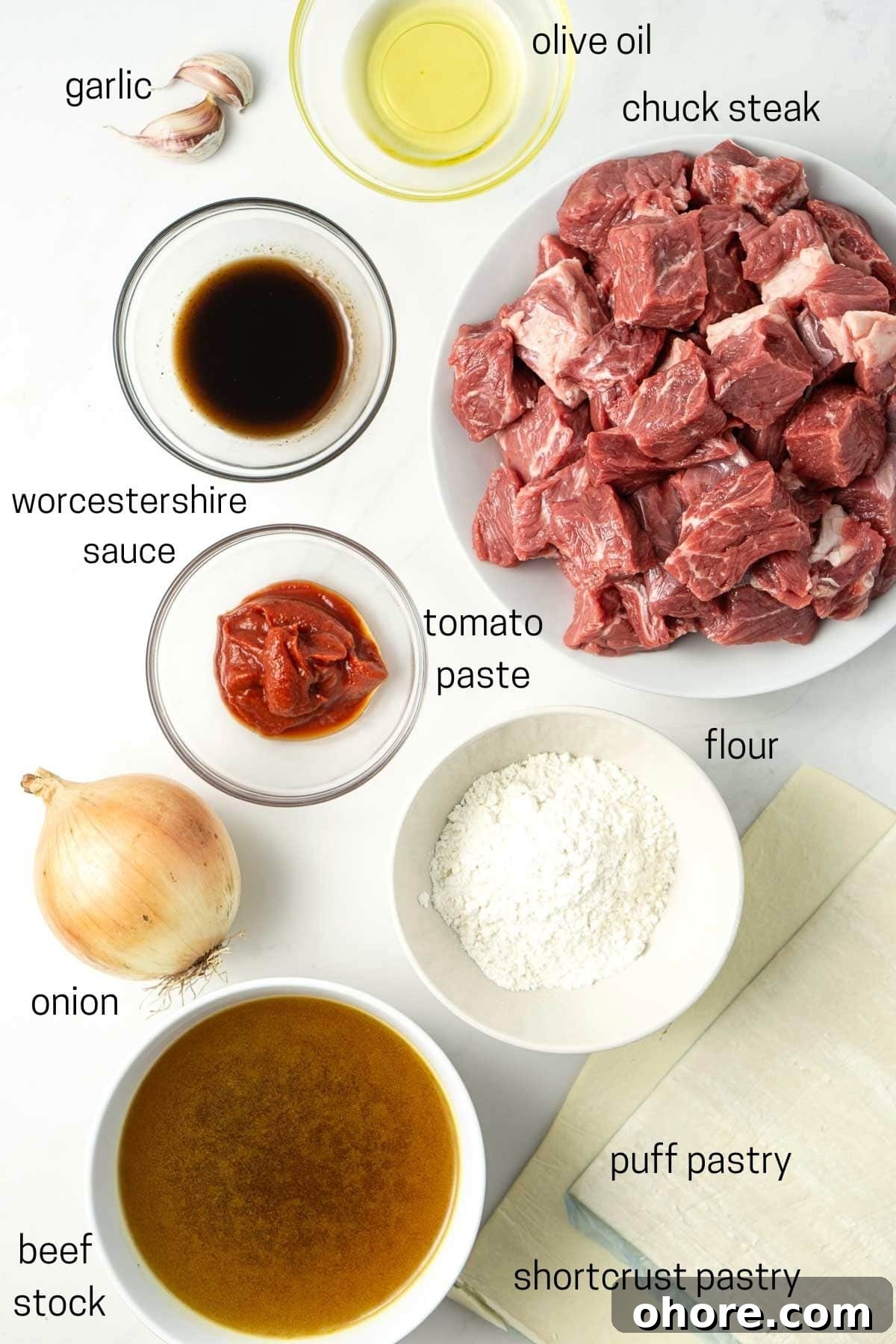 All ingredients needed to make mini beef pies laid out in small bowls.