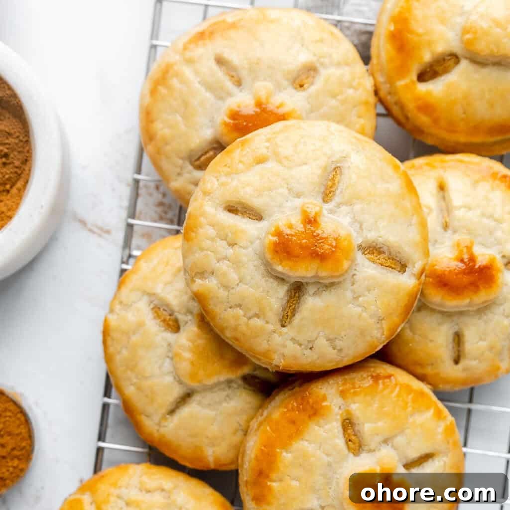 close up of pastry with pumpkin decorations stacked.