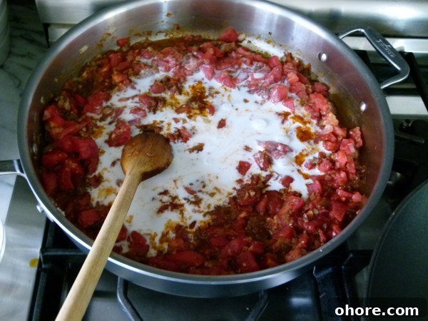Authentic Chicken Tikka Masala Recipe with Creamy Tomato Sauce 6 stir coconut milk into the tomato-spice mixture