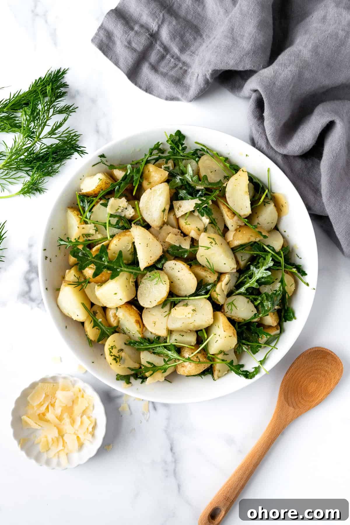 Arugula Potato Salad on a marble countertop.