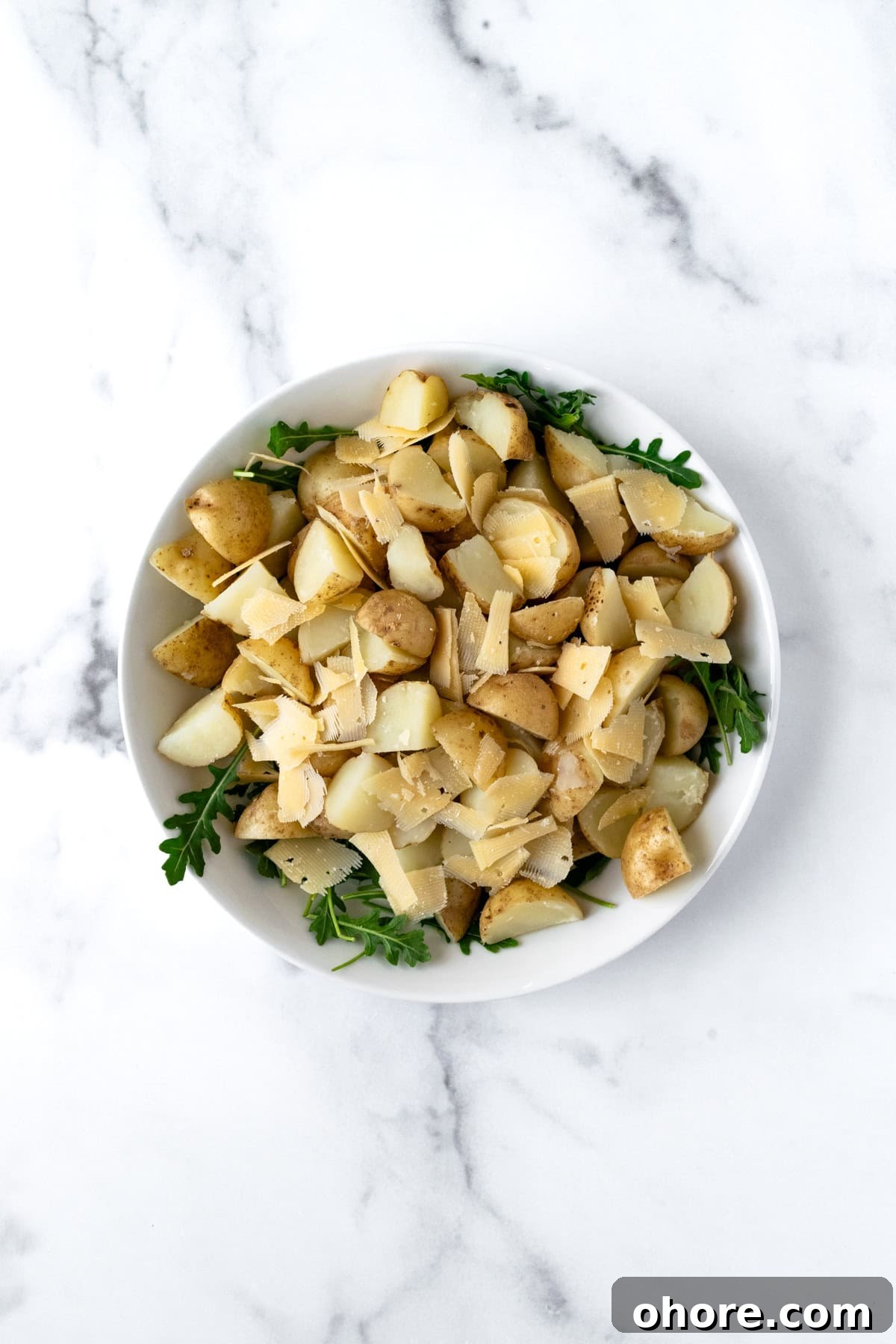 Arugula Potato Salad Ingredients in a large bowl.