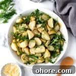Arugula Potato Salad in a white serving bowl.