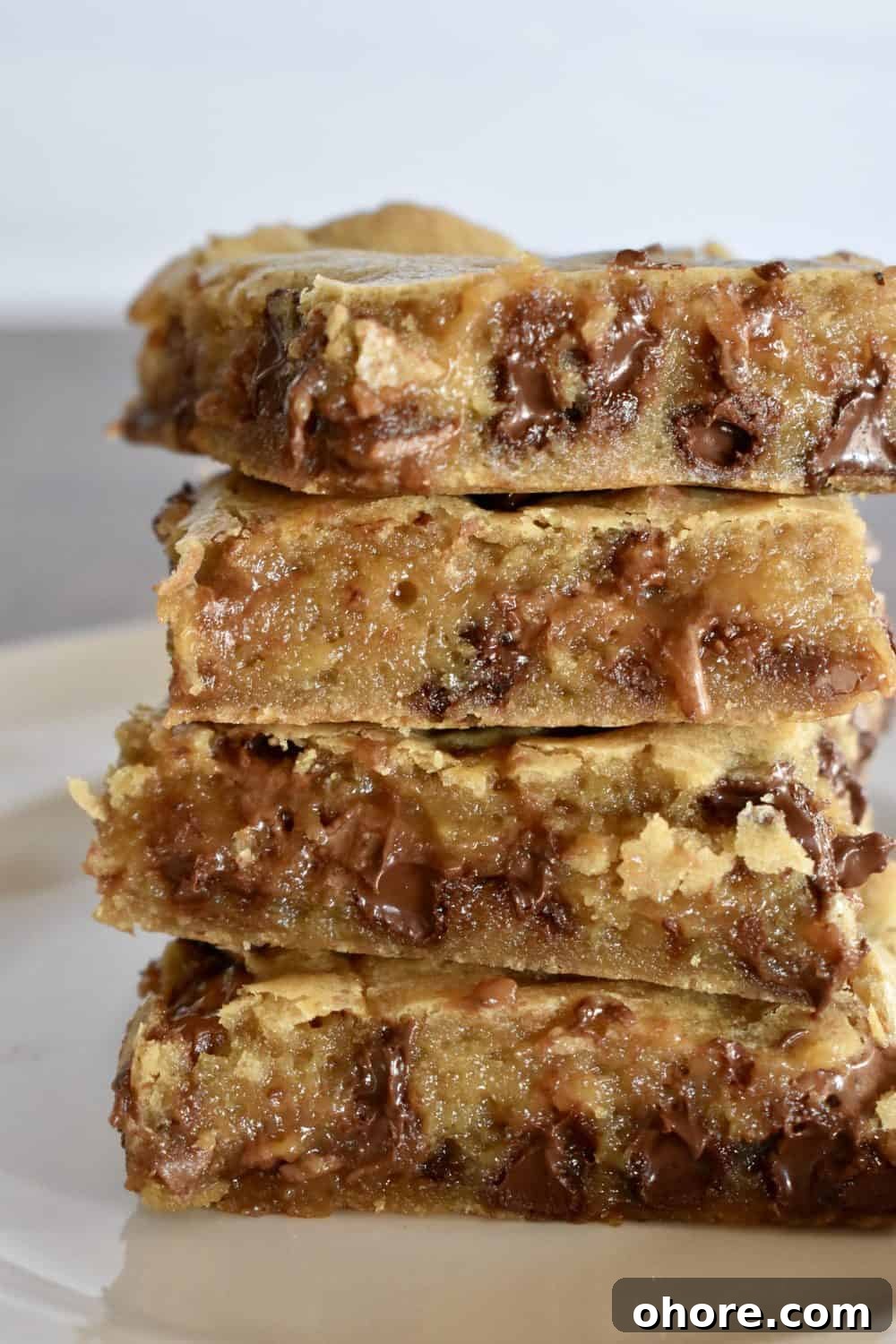 Milky Way Blondies with Caramel and Chocolate Delight 12 Milky Way Blondies stacked on top of each other.