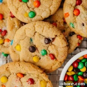 Soft Chewy Mini M&M Cookies — Small Batch Recipe 13 rainbow mini m&m cookies with a small bowl of mini m&ms