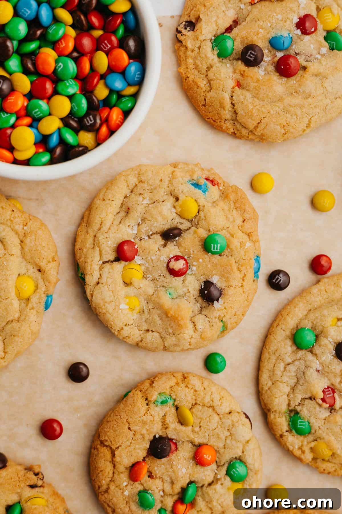 Soft Chewy Mini M&M Cookies — Small Batch Recipe 8 rainbow mini m&m cookies on parchment paper.