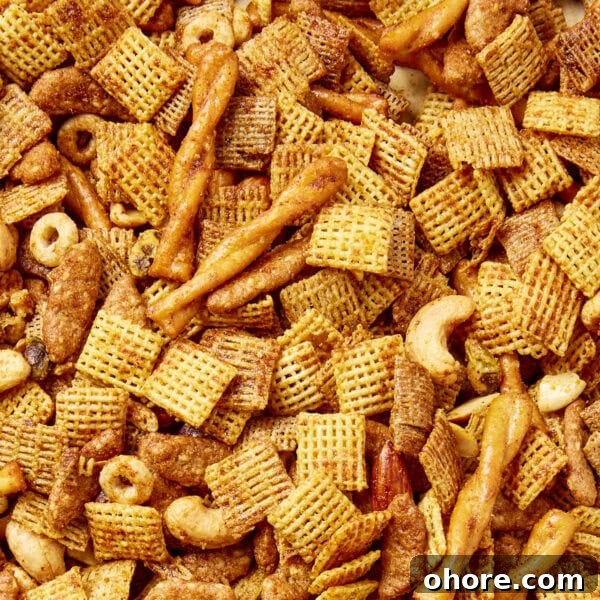 Sweet Smoky Party Snack Mix for Gatherings 6 Smoky party mix made from a mixture of cereal, pretzels, and nuts.