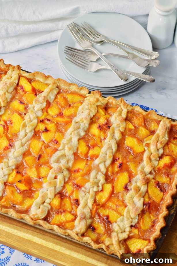 Rustic Peach Slab Pie Recipe for Serving a Crowd 2 Full sheet pan of peach slab pie with braided top crust