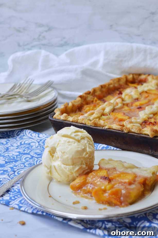 Rustic Peach Slab Pie Recipe for Serving a Crowd 7 scoop of vanilla a ice cream and slice of peach pie