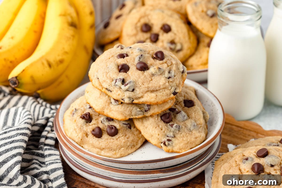 Banana Chocolate Chip Cookies Recipe — Moist Banana Cookies with Chocolate Chunks 6 Buttery chocolate chip cookies with bananas and milk in the background, fresh baked goods ready to enjoy.