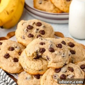 Banana Chocolate Chip Cookies Recipe — Moist Banana Cookies with Chocolate Chunks 8 Buttery banana chocolate chip cookies with chocolate morsels stacked on a plate.