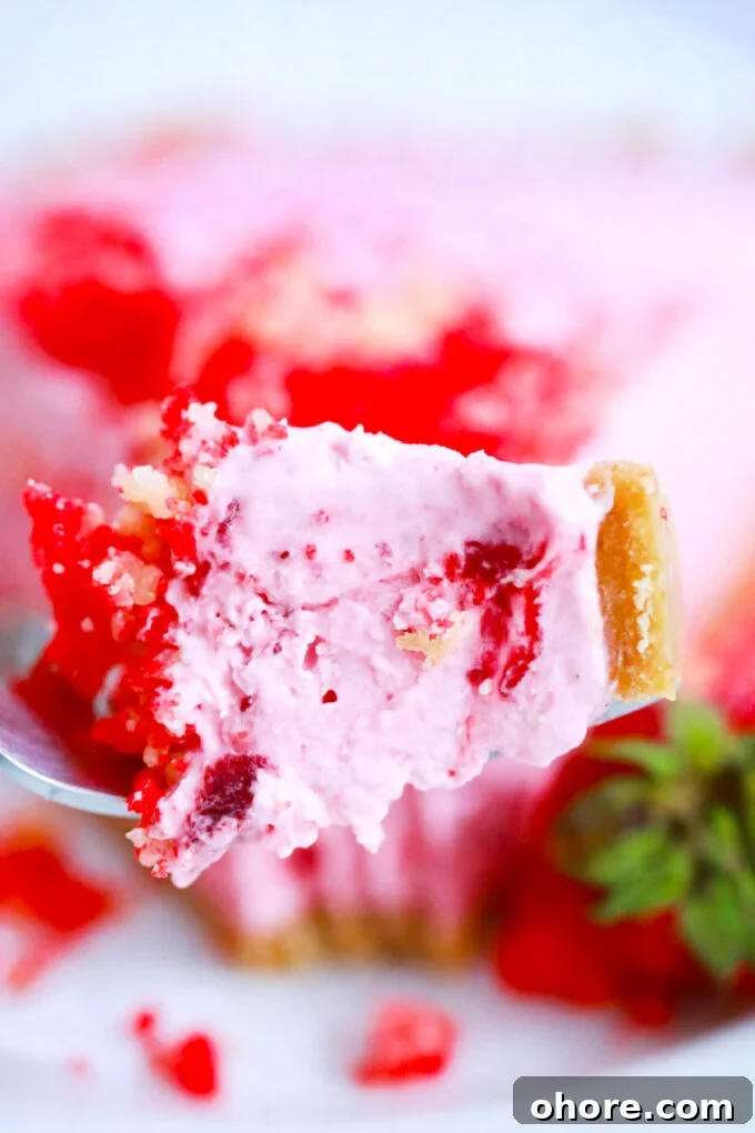 A bite of creamy strawberry shortcake pie.