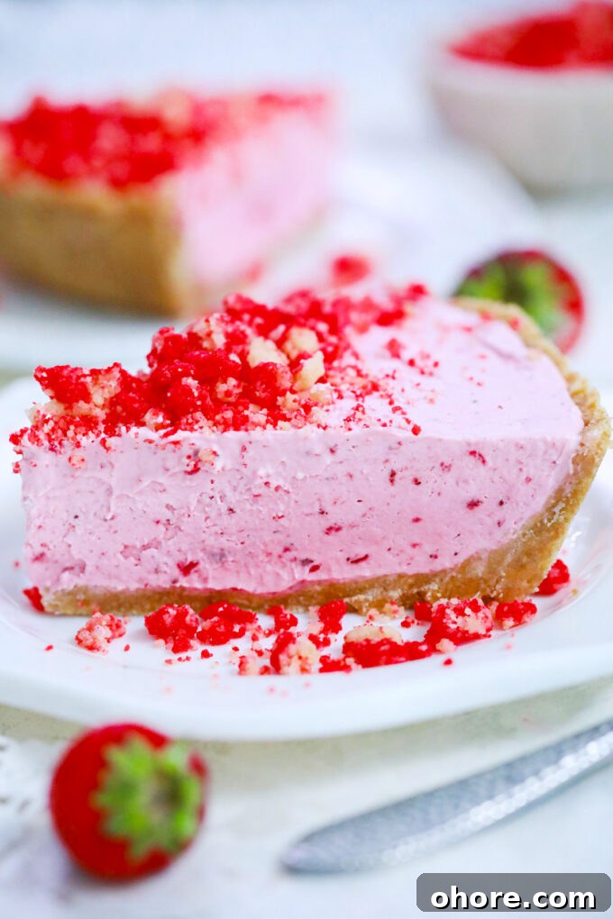 A slice of strawberry shortcake pie of strawberry crumb topping.