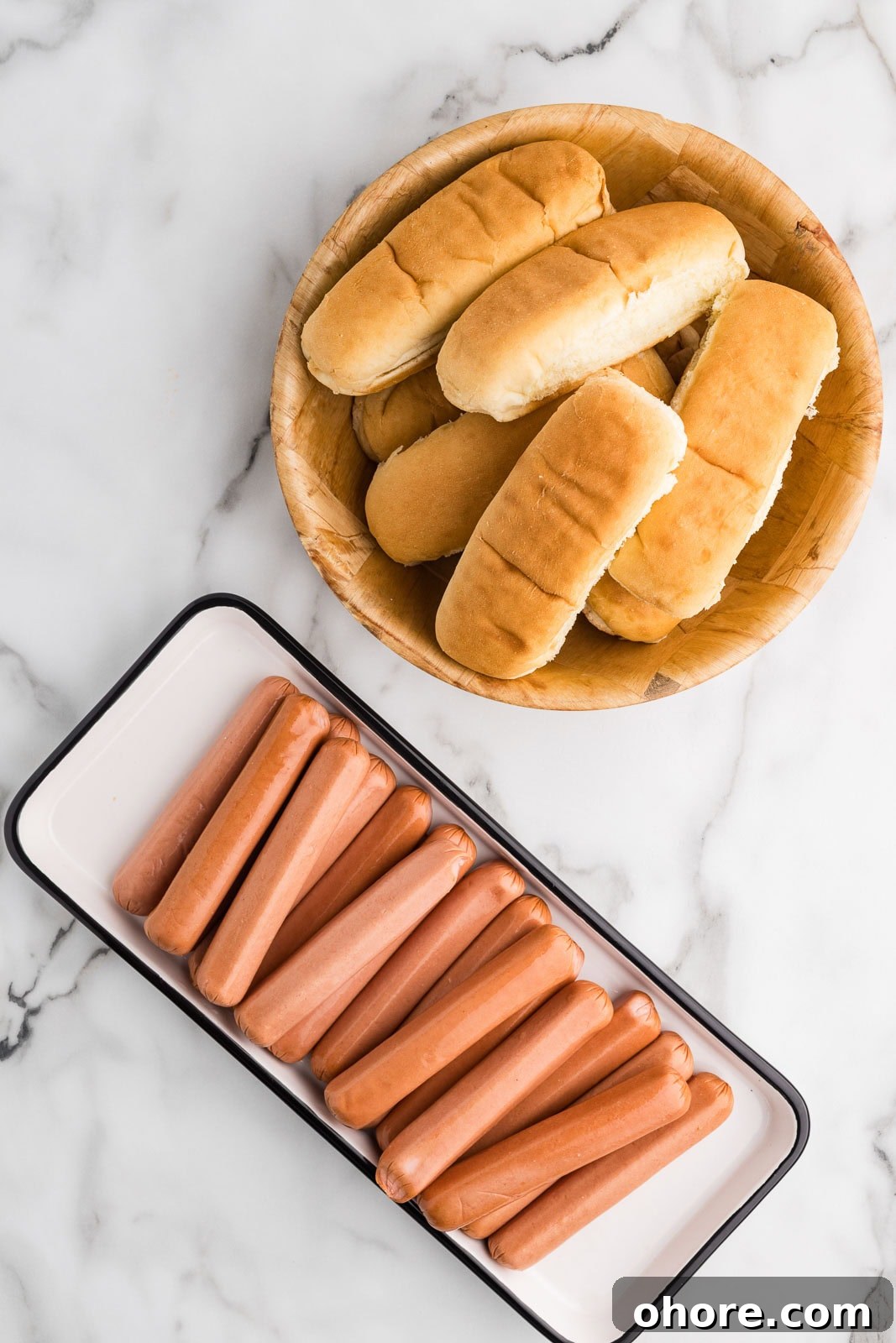 Slow Cooker Hot Dogs: Juicy, Fuss-Free Recipe and Tips 3 ingredients to include white plate with 24 hot dogs and basket with multiple hot dog buns