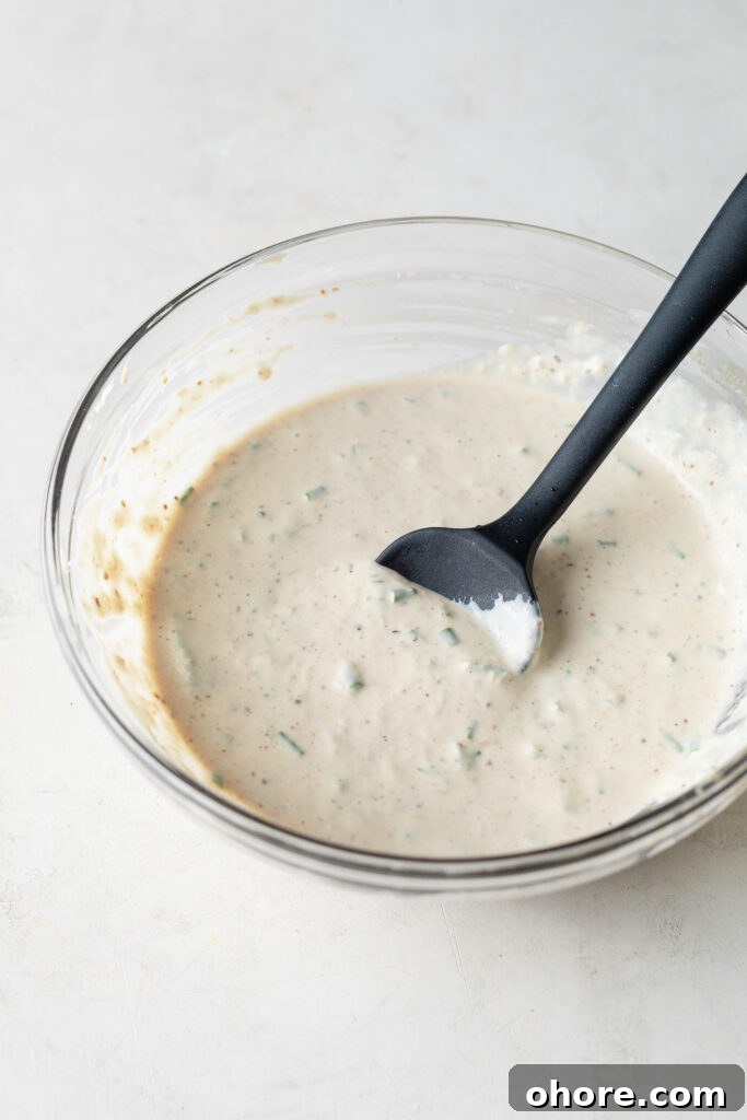 Creamy Horseradish Sauce for Prime Rib: Tangy Roast Beef Topping 2 Bowl of Horseradish Prime Rib sauce with black silicone spatula.