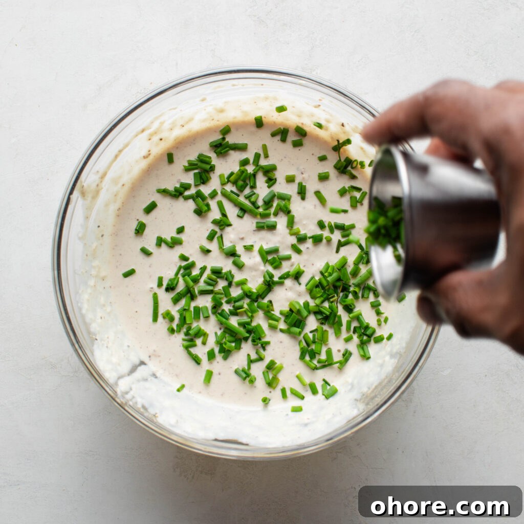 Creamy Horseradish Sauce for Prime Rib: Tangy Roast Beef Topping 6 Adding chives to Horseradish Prime Rib Sauce.
