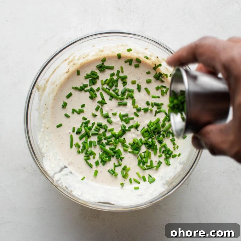Creamy Horseradish Sauce for Prime Rib: Tangy Roast Beef Topping 8 Adding chives to Horseradish Prime Rib Sauce.