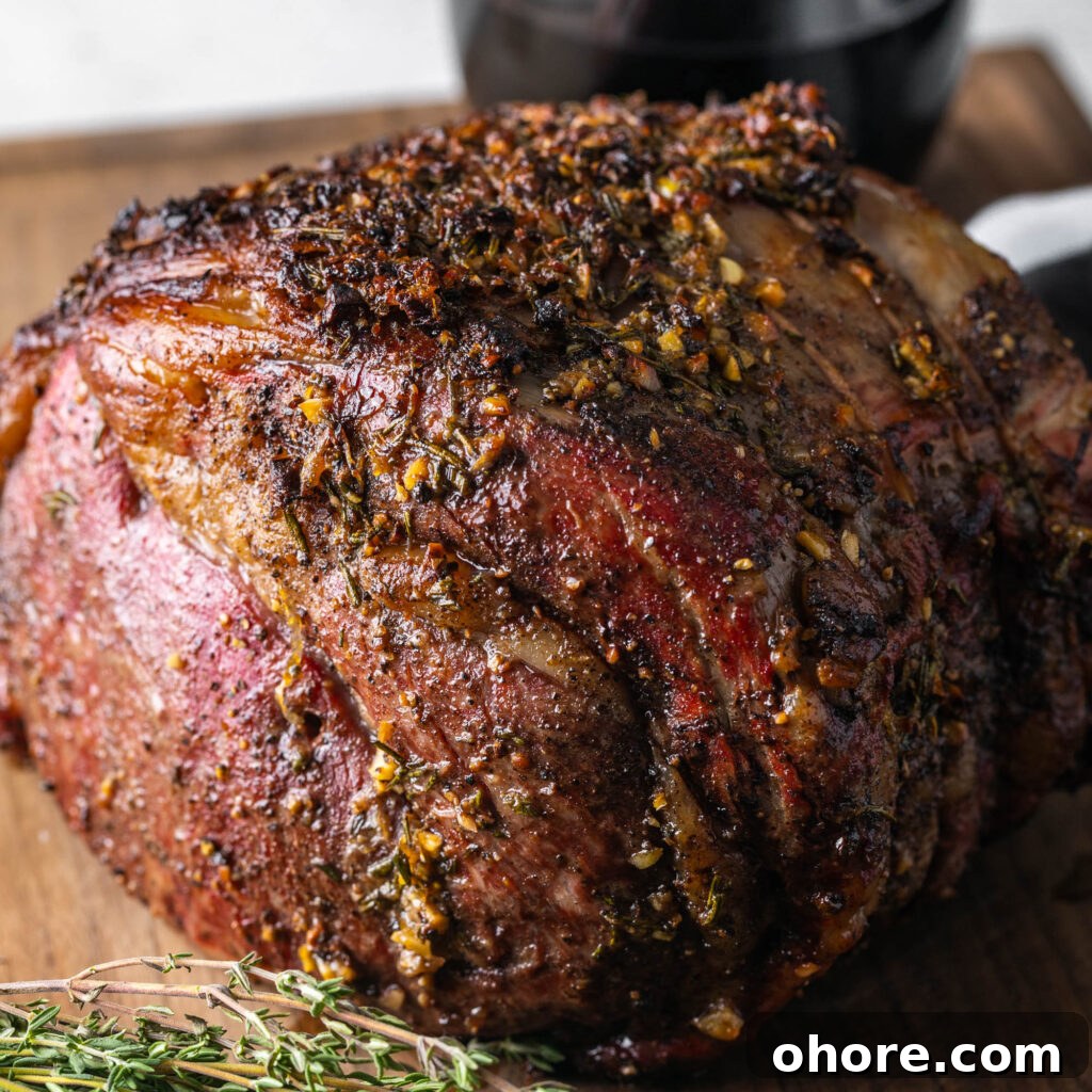 Creamy Horseradish Sauce for Prime Rib: Tangy Roast Beef Topping 9 Herb crusted Prime Rib resting on cutting board with thyme sprigs.